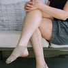 Dancer wearing low-profile performance dance socks seated, lifestyle view