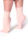 Adult wearing pink ribbed dance socks above the ankle