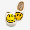 Side view of yellow smiley face slippers showing plush fleece texture