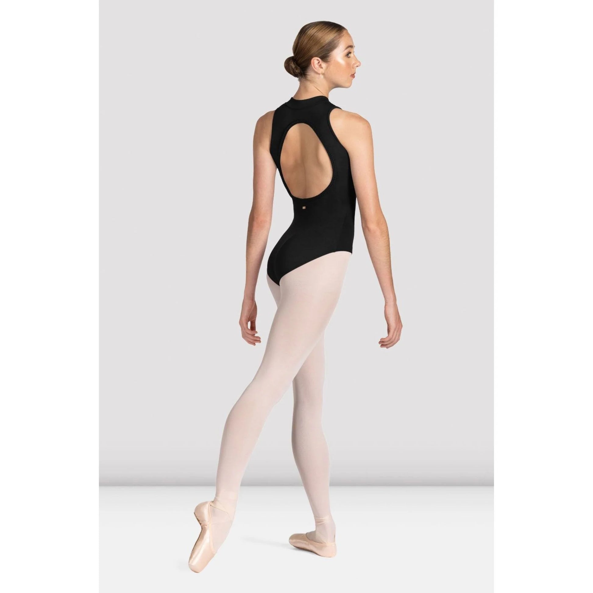 Adult dancer wearing black zip-front leotard, side view
