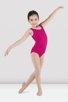 Child dancer wearing bright pink tank leotard posing with arm raised