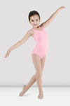 Child dancer wearing candy pink tank leotard posing in dance stance
