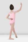 Child dancer wearing candy pink tank leotard posing in dance stance