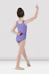 Child dancer wearing lavender tank leotard standing in ballet pose