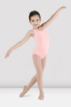 Child dancer wearing light pink tank leotard posing in dance position