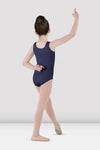 Child dancer wearing navy blue tank leotard posing with arm raised