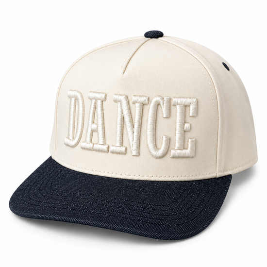 A structured baseball cap with an off-white crown and a dark navy blue brim. The front of the crown features the word 'DANCE' embroidered in large, raised block letters on the front panel.