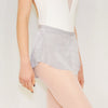 Adult ballet dancer wearing a light gray pull-on ballet skirt over a leotard