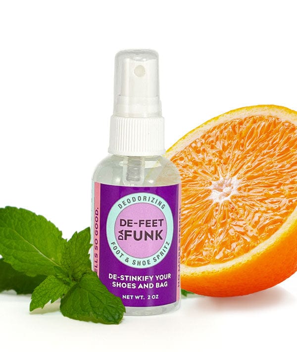 Bottle of deFEET da FUNK deodorizing foot and shoe spray with orange slice and mint leaves
