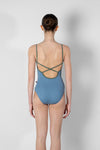 Child model wearing a light blue camisole leotard, shown from the back.