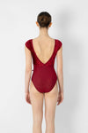 Adult model wearing a red short sleeve leotard, shown from the back.