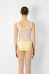 Adult model wearing a light neutral tank leotard with mesh back, shown from the back.