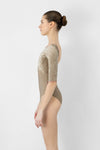 Adult model wearing neutral 3/4 sleeve leotard shown from the side.