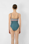 Model wearing teal and pink camisole leotard back view