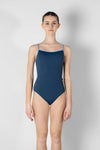 Child model wearing a navy camisole leotard, shown from the front.