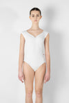  Adult model wearing a two-tone cap sleeve leotard, shown from the front.