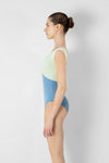 Side view of adult model wearing a cap sleeve leotard.

