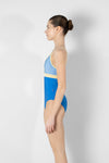 Model wearing teal and pink camisole leotard side view