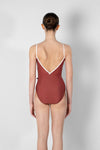 Model wearing red camisole leotard back view
