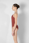 Model wearing red camisole leotard side view