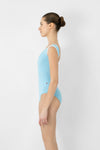 Side view of adult model wearing a cap sleeve leotard.