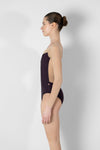 Side view of adult model wearing a tank leotard with mesh back panel.