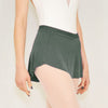 Adult ballet dancer wearing a deep green pull-on ballet skirt over a leotard