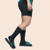 Black knee-high dance socks worn with dance shoes, side view