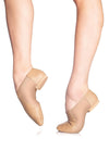 Side view of adult dancer wearing caramel leather jazz shoes showing heel and sole