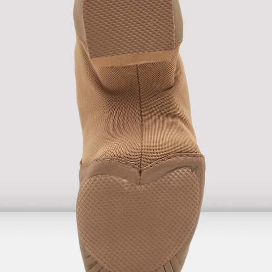 Sole view of a tan slip-on leather jazz shoe showing the split sole.
