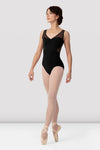 Adult dancer wearing a black V-neck tank leotard with mesh neckline
