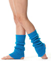 Turquoise 40 cm knit legwarmers worn over tights, scrunched above the ankle.
