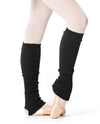 Black 60 cm knit leg warmers worn over tights.