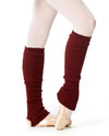 Burgundy knit leg warmers worn over tights and ballet shoes.