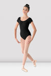 Adult ballet dancer wearing a black cap sleeve leotard with scoop neckline