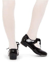 Child dancer wearing black patent leather tap shoes with elastic fastening, back view