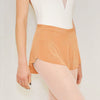 Adult ballet dancer wearing a warm orange pull-on ballet skirt over a leotard