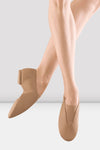 Adult dancer wearing tan slip-on split-sole jazz shoes, side view