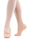 Child wearing pink full sole leather ballet shoes standing in ballet position on a white background