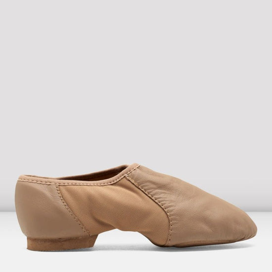 Side view of a tan slip-on leather jazz shoe on a white background.