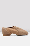 Side view of a tan slip-on leather jazz shoe on a white background.