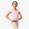 Child dancer wearing pink cap sleeve ballet leotard with rounded neckline.