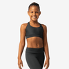 Young dancer wearing a black tank-style dance top, standing facing forward against a light background.