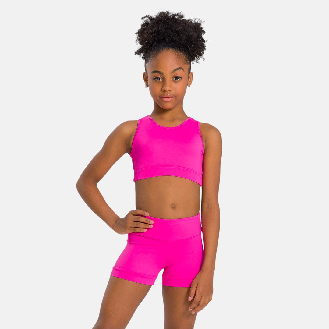 Young dancer wearing dark pink halter dance top with coordinating dance shorts