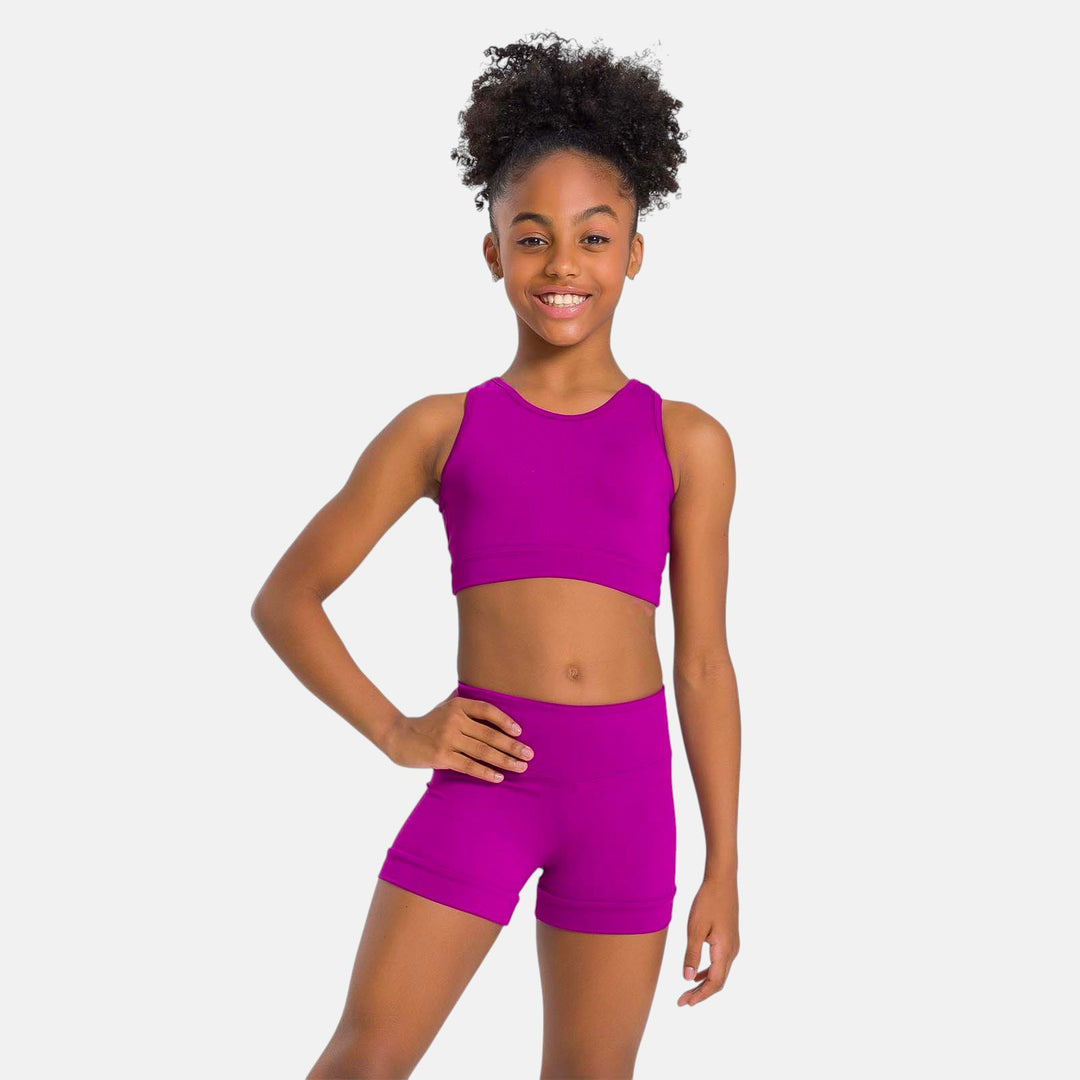 Young dancer wearing raspberry mesh-strap dance top with coordinating shorts