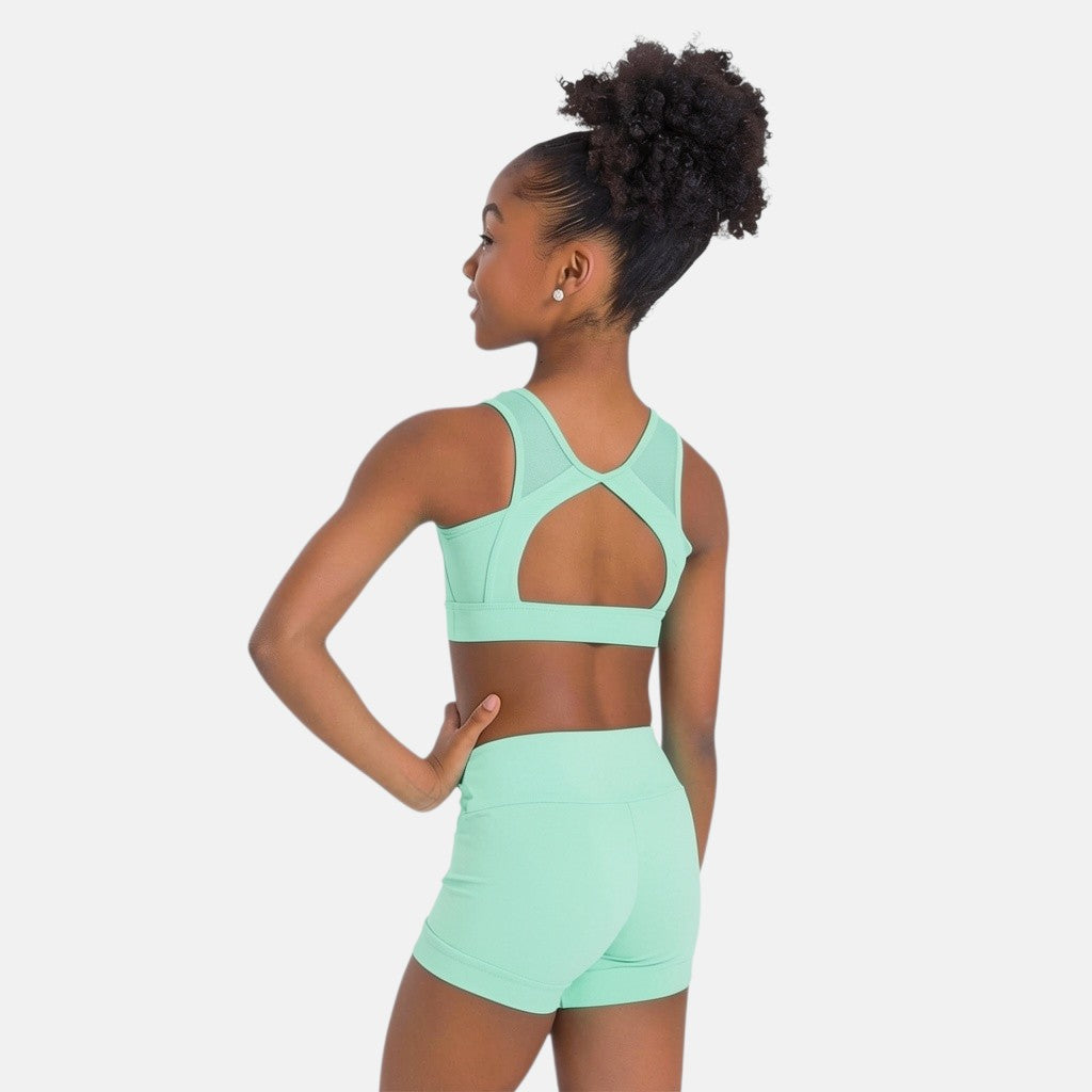 Young dancer wearing mint green halter dance top with coordinating shorts