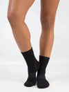 Dancer wearing black ankle-length performance socks, shown from the front.
