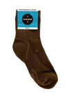 Packaged Sugar and Bruno performance sock in brown packaging.