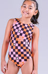 Front view of a pink gymnastics leotard with a black and orange checkerboard pattern and spooky graphic designs.