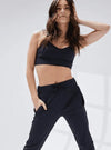 Black adult jogger pants shown from the front on a dancer
